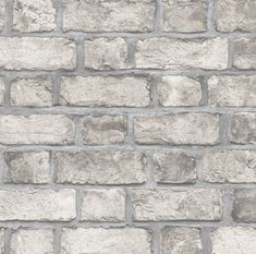 a brick wall with grey and white bricks