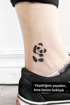 a small tattoo on the ankle of a woman's foot with a panda bear