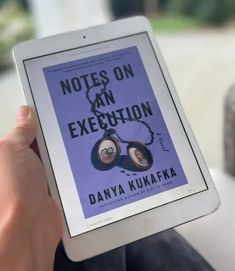 a person holding an ipad with a book cover on it's screen and the title notes on an exception