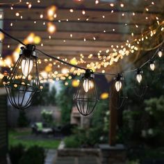 some lights are hanging from the ceiling in front of a gazebo covered with string lights