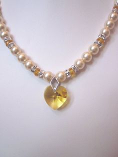 Swarovski Pearl and Crystal Necklace - Swarovski Pearls and Golden Yellow Crystal Heart - Weddings, Heart-shaped Beaded Wedding Necklaces, Heart Cut Jewelry With Heart Beads For Wedding, Wedding Heart-shaped Beaded Necklaces, Pearl Necklaces For Wedding And Valentine's Day, Pearl Necklace For Wedding And Valentine's Day, Valentine's Day White Pearl Necklace For Wedding, Wedding Pearl Necklaces With Heart Beads, Beaded Crystal Bridal Necklace For Anniversary, Crystal Beaded Bridal Necklace For Anniversary