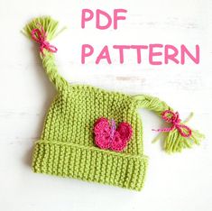 a green knitted hat with a pink heart on it and the words pdf pattern above it