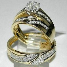 two gold wedding rings with diamonds on each one and an engagement ring in the middle