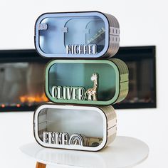 three tins stacked on top of each other with the word giraffe in them