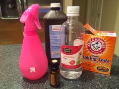 a counter top with bottles, soap and other items on it in front of a microwave