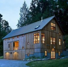 a large wooden building with lots of windows on it's sides and lights in the windows