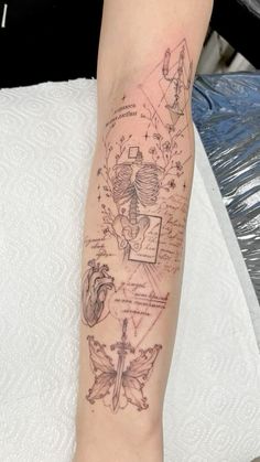 a person with a tattoo on their arm that has many different things in the background