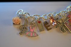 🏆 Bestseller! Tell YOUR story through charms. Each bracelet is custom made to order, personalized to your person and occasion. Unlike others, our bracelets are NOT mass produced and will not look like any other. This listing features two different charms bracelets, both made for two little girls as their very first charm bracelets. (I'm honored!) Each bracelet features charms that are personal to each girl, featuring things they enjoy, what they love, personalized with birthstones, initials and Personalized Pink Sterling Silver Charm Bracelet, Themed Charm Jewelry For Birthday, Personalized Pink Charm Bracelet For Anniversary, Themed Birthday Jewelry With Charms, Hawaiian Bracelets, Unicorn Jewelry, Travel Charms, Charms Bracelets, Your Person