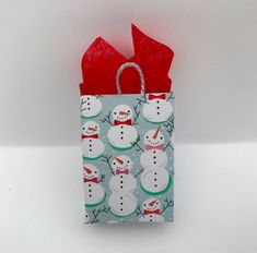 a paper bag with snowmen on it