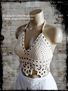 a mannequin wearing a white crochet top