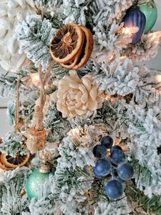 a decorated christmas tree with dried oranges and pine cones