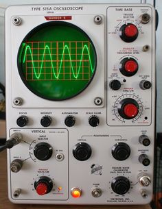 an oscilloscope sitting on top of a wooden table