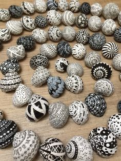 there are many different types of beads on the table, including one with black and white designs