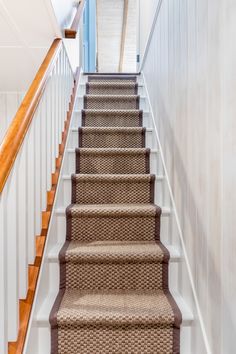 a staircase with carpeted steps leading up to the second floor