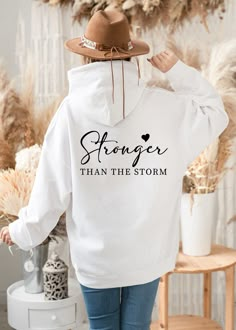 Stronger Than The Storm Sweatshirt Hoodie, Sweatshirts with Sayings Quotes for Women, Inspirational Motivational Sweatshirt, Mental Health, Gift for women Hello there! Welcome to ☆Star Fashion Sweatshirt-Hoodie☆ store.  We are here for different and top quality models. All of your designs that we hope you will like in our store are specially designed and produced for you. Do not hesitate to review. ☆Enjoy comfort and elegance. The material is a thick cotton and polyester blend. It is also a grea Shirt Saying Ideas, Quotes For Sweatshirts, Positive T Shirt Sayings, Cricut Hoodie Ideas Women, Christian Sweaters For Women, Cricut Sweatshirt Ideas Women Trendy, Cricut Sweatshirt Ideas Women, Cricut Tshirt Ideas For Women, Tshirt Ideas Design Vinyls