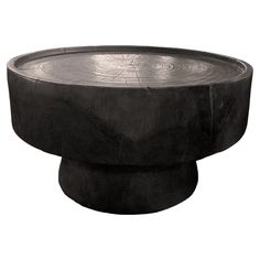 a black table with a circular design on it's top and bottom, sitting in front of a white background