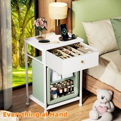 a small white table with drawers on it and a teddy bear sitting next to it