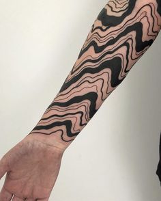 a man's arm with black and white lines on it, as well as his hand