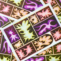 several square stickers with different colors and shapes on the same pattern as seen from above