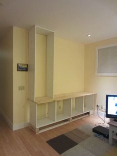 a living room filled with furniture and a flat screen tv sitting on top of a hard wood floor