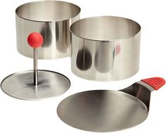 three stainless steel measuring cups and spoons with red knobs on each one side