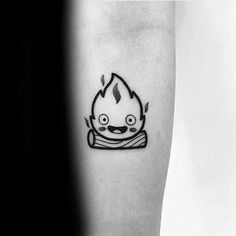 a black and white photo of a cartoon character tattoo on the left inner forearm,