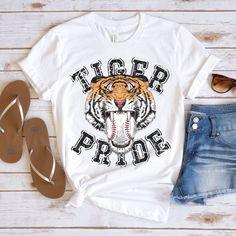 The Tiger Pride baseball t-shirt is perfect for all the game. This distressed tiger tee is everything you've dreamed of and more. This adorable and soft shirt makes a great gift for tiger baseball fans to wear to all the baseball game or just everyday wear! It feels soft and lightweight, with the right amount of stretch. It's comfortable and flattering for all.  Show off your personality with our fun and unique designs!   ** P R O D U C T   D E T A I L S **  - High Quality, Super Soft and Comfy Bella + Canvas T-Shirt  - 100 % Pre-Shrunk Cotton  (heather colors are polycotton blend)  - Direct to Garment print (no stencils or vinyl which means it will last a lot longer)   - Printed and Shipped in the USA  - Due to different monitor screens colors may vary ** S I Z I N G **  - Consult size ch Tigers Baseball Shirts, Tigers Spirit Wear, High School Baseball Shirts, Tiger Shirts, Baseball Shirts For Moms, Tigers Shirt, Tiger Mascot, Go Tigers, Baseball Stuff