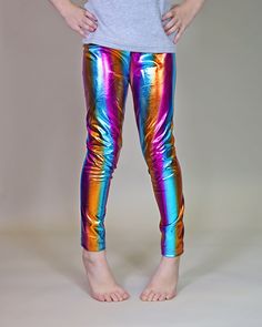 "Glitzy, shimmery, metallic pants, while lightweight fabric little ones comfy. These glam metallic pants are fun, and fashionable and your little lady will love wearing them with their perfect amount of pizazz and shine.  100% polyester  We recommend hand washing and hang drying this article of clothing to keep the metallic shine from fading * 3 year - 21\" waist / 23 1/2\" length * 4 year - 21 1/2\" waist / 25\" length * 5 year - 22 1/2\" waist / 26 1/2\" length * 6 year - 24\" waist / 27 1/2\" length * 7 year - 26 1/2\" waist / 27 1/2\" length * 8 year - 28\" waist / 30\" length * 10 year - 29 1/2\" waist / 32 1/2\" length * 12 year - 30 1/2\" waist / 34\" length * 14 year - 32\" waist / 35\" length" Metallic Shimmer Disco Pants, Stretch Multicolor Pants For Party, Stretch Multicolor Party Pants, Multicolor Stretch Pants For Party, Multicolor Leggings For Spring Party, Metallic Fitted Leggings For Party, Shiny Metallic Leggings For Party, Metallic Shiny Leggings For Party, Metallic Stretch Pants For Party Season