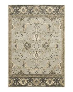 a rug with an ornate design on the top and bottom, in light grey tones