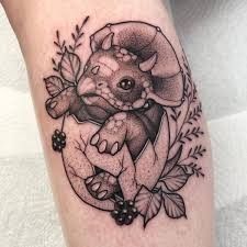 a black and white photo of a tattoo on the leg of a person with an animal