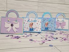 three frozen princess handbags are shown with confetti scattered around them on a table