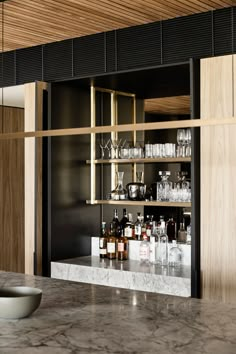 an empty bar with bottles and glasses on the counter in a modern restaurant or bar