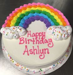 a birthday cake with rainbow frosting on it