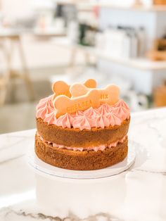 a close up of a cake on a table with other food items in the background