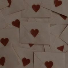 many envelopes with brown hearts on them