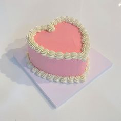 a heart shaped cake sitting on top of a table