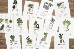 calendars with plants on them sitting on top of a wooden table next to each other