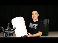 a man holding a large white cup in front of a black background with the words diy on it