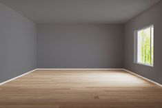 an empty room with wood floors and gray walls