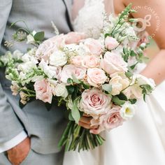 the bride and groom are holding their wedding bouquet