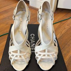 Chanel Off White/Beige Patent Leather Heeled Sandal. Comes With Dust Bags And Box. Worn Twice In Good Condition. Scuff Shown In Picture. (1/18) Chanel Cream, Shoes Chanel, Leather Heels Sandals, Heeled Sandal, Patent Leather Heels, Chanel Shoes, White Beige, Heeled Sandals, Cream White