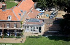 an aerial view of a large brick house with orange roofing and red tiled roofs