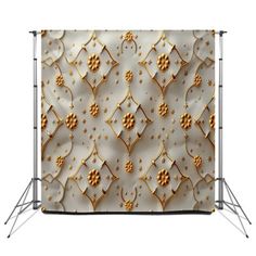 a white backdrop with gold flowers and stars on the wall, it is ready to be used