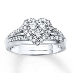 a heart shaped diamond ring with two rows of diamonds on the band, set in 18k white gold