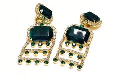 Embody vintage elegance with the Kenneth Jay Lane 1960's earrings. Crafted with long, gold-plated tassels and sparkling green crystals, these earrings exude sophistication and luxury. Elevate any outfit with this timeless and exclusive accessory. Approximate Measurements: Length 3.2", Width 1.35". Made in USA. Glamorous Green Chandelier Earrings For Evening, Green Chandelier Earrings For Evening, Ornate Green Earrings For Formal Occasions, Green Clip-on Earrings For Evening, Vintage Green Jeweled Earrings, Luxury Ornate Green Earrings, 1960s Earrings, Kenneth Jay Lane Jewelry Vintage, Vintage Hallmarked Green Earrings