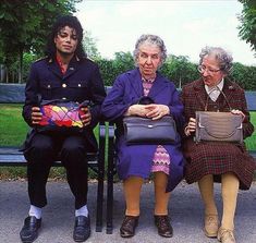 three elderly women sitting on a bench in the park