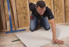 a man in black shirt and glasses laying on floor