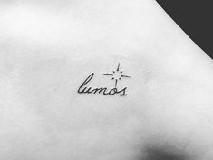 a woman's back with the word lumos written in cursive writing