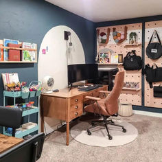 a room with a desk, chair and shelves