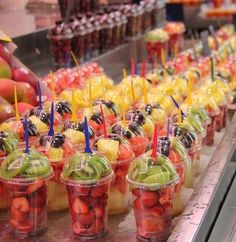 many cups filled with different types of fruit